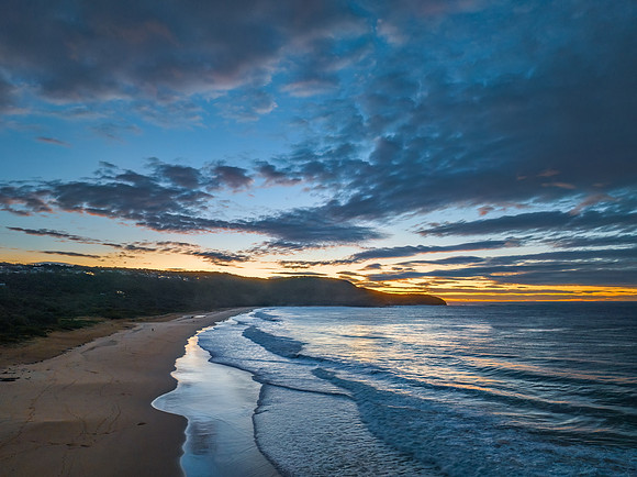 Surf, sea, sand, sunrise with clouds
