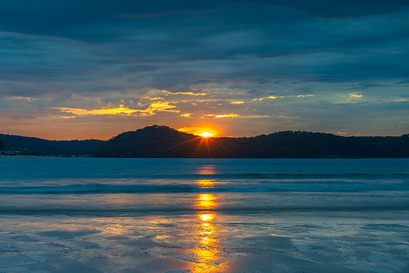 Colourful cloud filled sunrise at the seaside