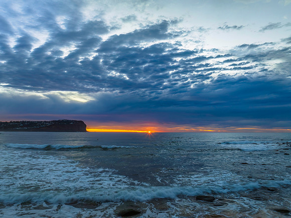 Cloud filled sunrise seascape