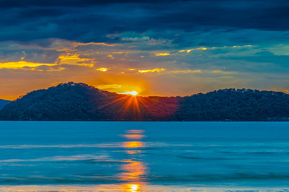 Colourful cloud filled sunrise at the seaside