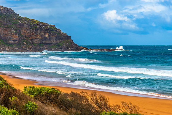Scenic views at the seaside with waves and clouds in the sky