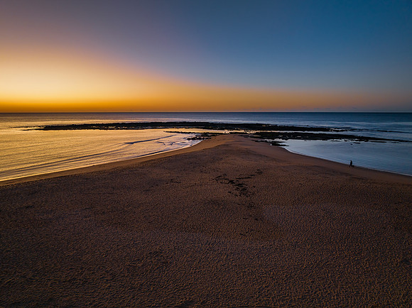 Sunrise with clear skies and calm seas