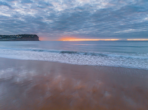 Stratus cloud filled sunrise over the ocean