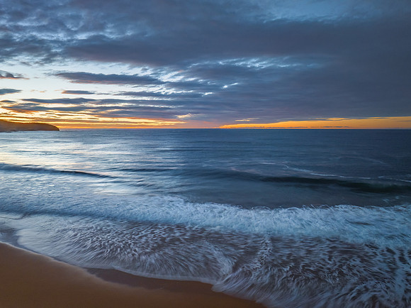 Surf, sea, sand, sunrise with clouds