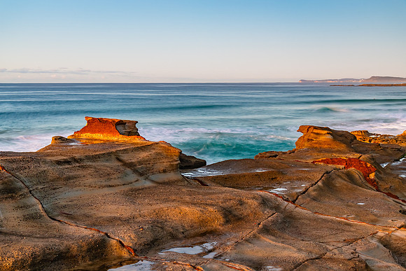 Sunrise seascape with rock platform