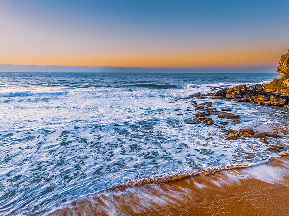 Sunrise and waves at the seaside