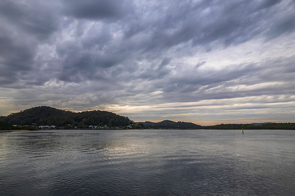 Cloud covered aerial sunrise waterscape