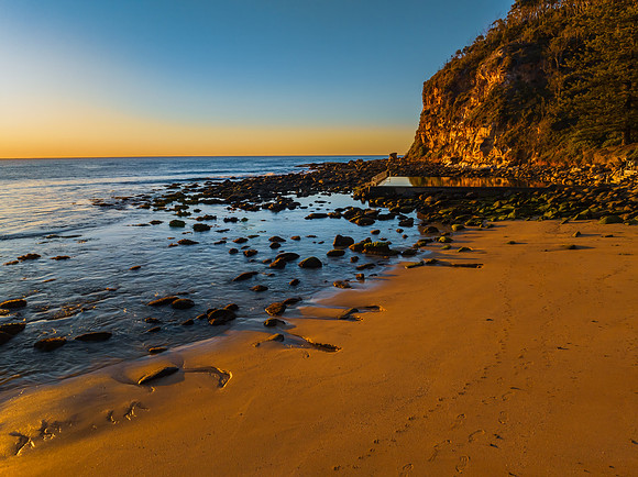 Clear skies and flat surf sunrise seascape