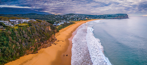 Cloud filled sunrise panorama over the beachside suburb