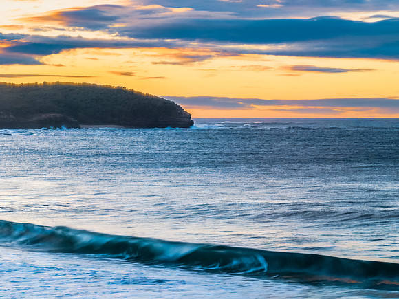 Surf, sea, sand, sunrise with clouds