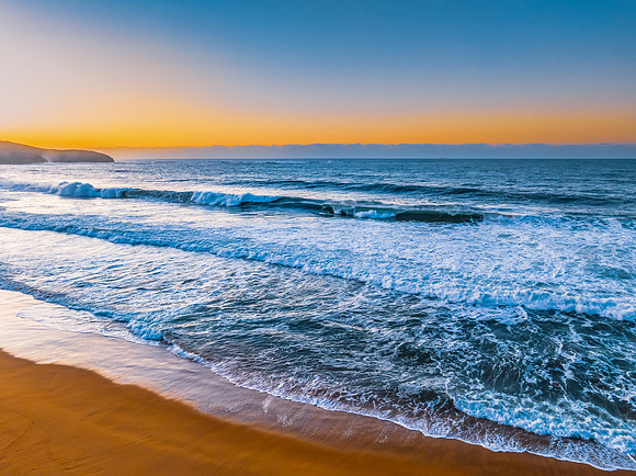 Sunrise and waves at the seaside