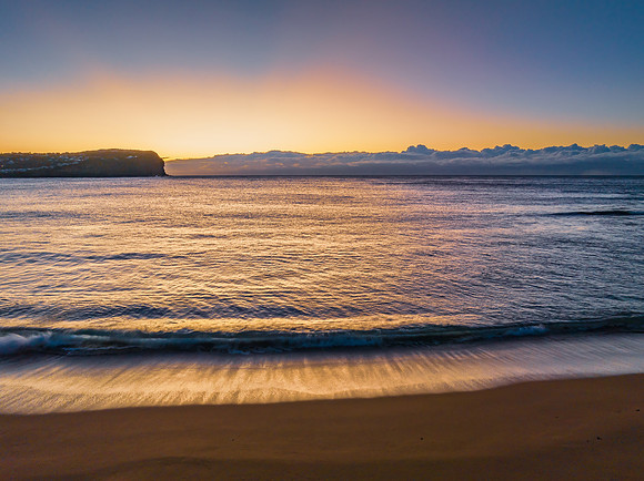 Sunrise over the ocean with low cloud bank