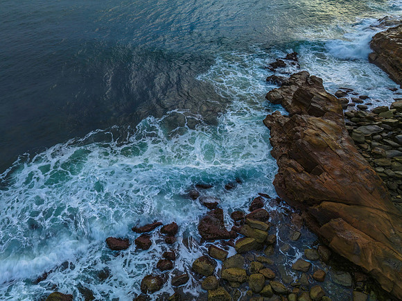 Top down rocks and the sea during sunrise