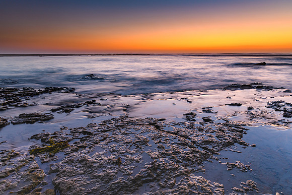 Sunrise Seascape and Rock Ledge in Blue and Orange