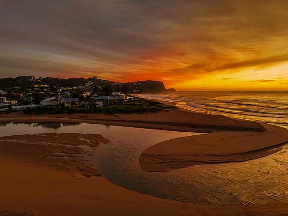 Sunrise and high cloud cover by the sea and lagoon