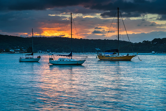 Overcast sunrise waterscape at the channel with boats
