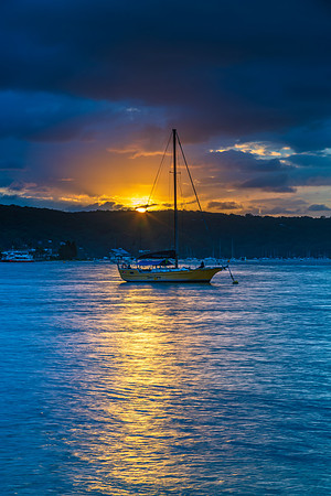 Overcast sunrise waterscape at the channel with boats