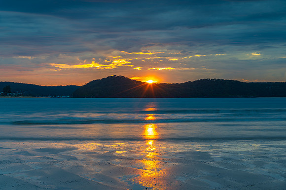 Colourful cloud filled sunrise at the seaside