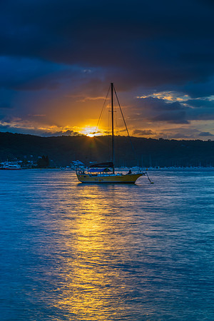 Overcast sunrise waterscape at the channel with boats