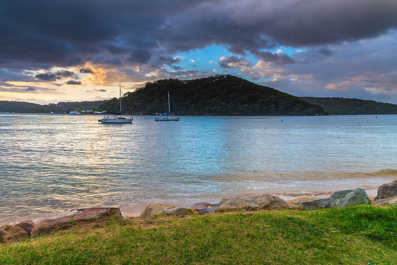 Overcast sunrise waterscape at the channel with boats