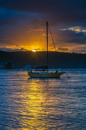 Overcast sunrise waterscape at the channel with boats