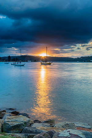 Overcast sunrise waterscape at the channel with boats