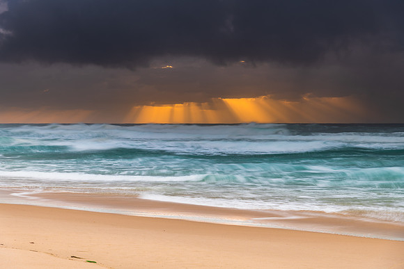 Rainy day moody seascape with sun rays
