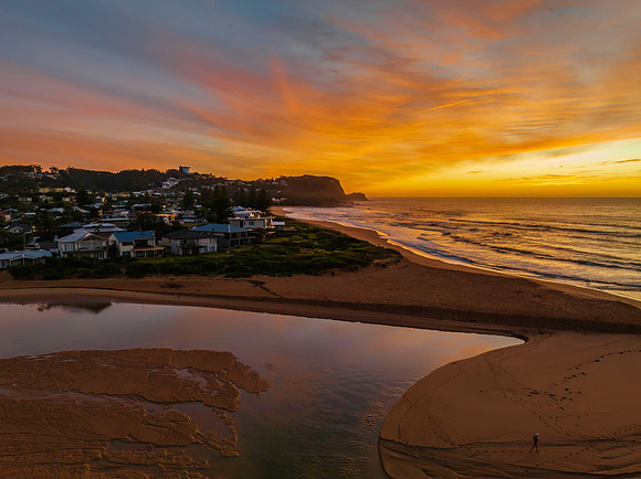 Sunrise and high cloud cover by the sea and lagoon