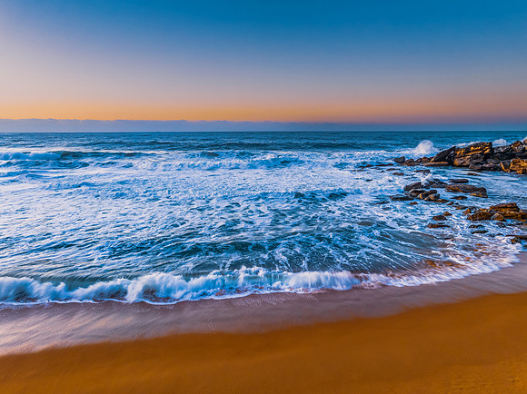Sunrise and waves at the seaside
