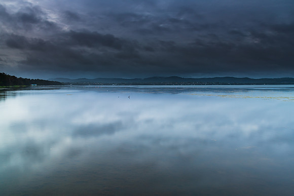 Rainy day early morning waterscape at the lake
