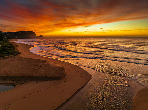 Sunrise and high cloud cover by the sea and lagoon