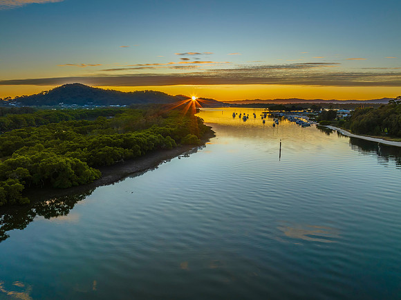 High cloud sunrise over the bay water