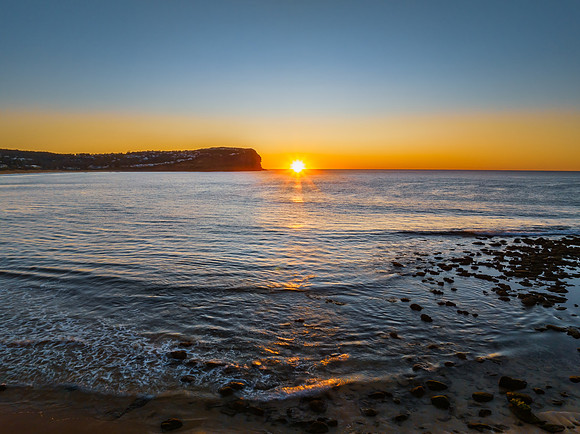 Clear skies and flat surf sunrise seascape