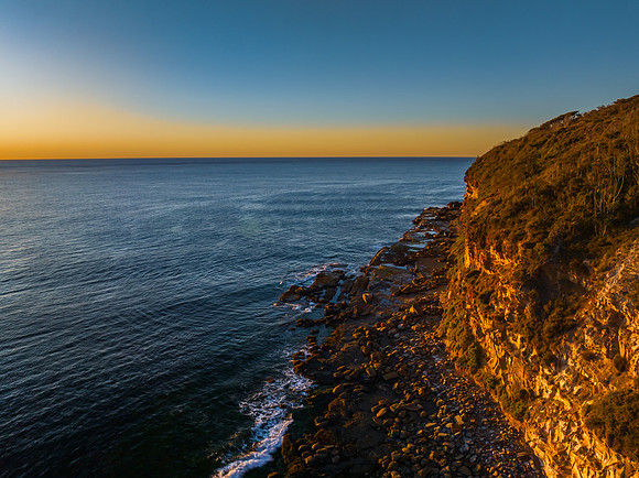 Clear skies and flat surf sunrise seascape