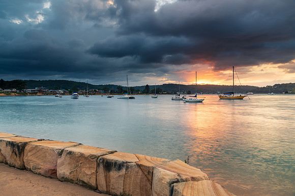 Overcast sunrise waterscape at the channel with boats