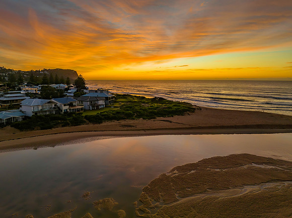 Sunrise and high cloud cover by the sea and lagoon