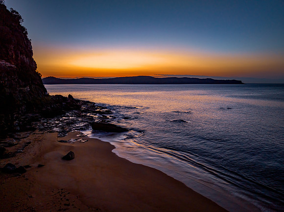 Aerial sunrise over the calm sea and smoke haze clear sky