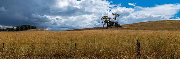 Countryside and storm clouds with blue sky