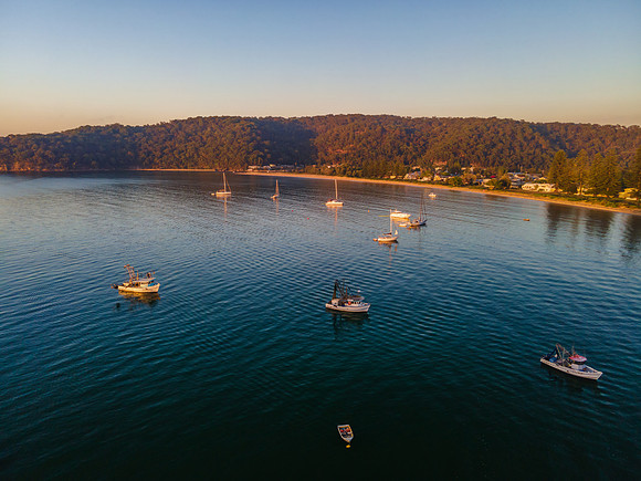 Boats at rest and gentle sunrise over the bay
