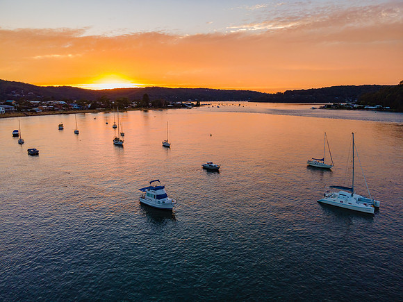 Aerial sunrise waterscape over the channel with orange clouds an
