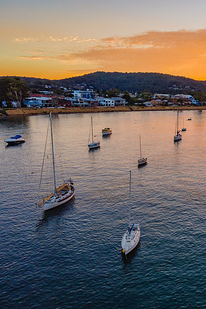 Aerial sunrise waterscape over the channel with orange clouds an