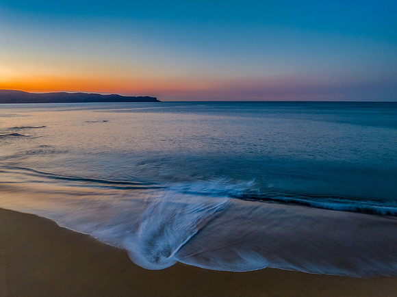 Aerial sunrise over the calm sea and smoke haze clear sky