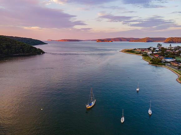 Aerial sunrise waterscape over the channel and boats