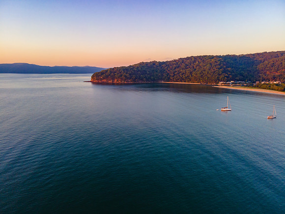 Boats at rest and gentle sunrise over the bay