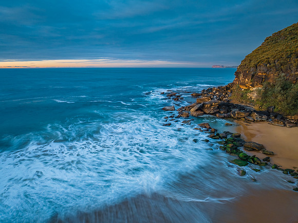 Surf, sea, sand, sunrise with clouds