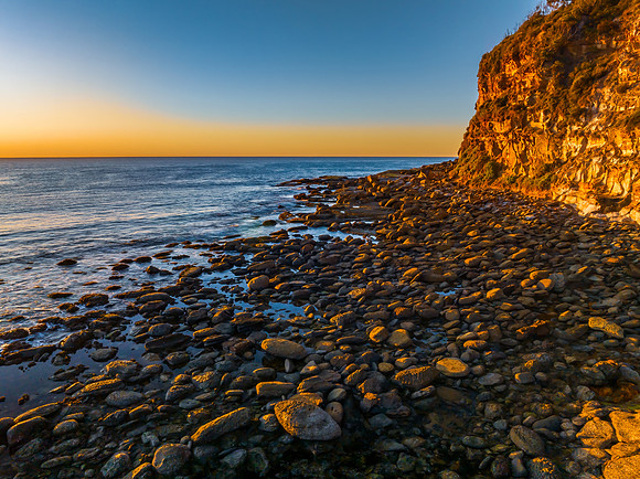 Clear skies and flat surf sunrise seascape