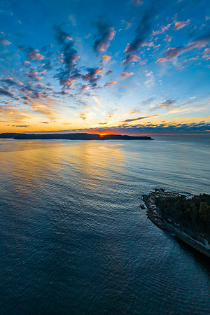 Aerial sunrise seascape with pretty cloud filled sky