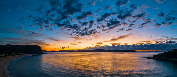 Aerial sunrise seascape with pretty cloud filled sky