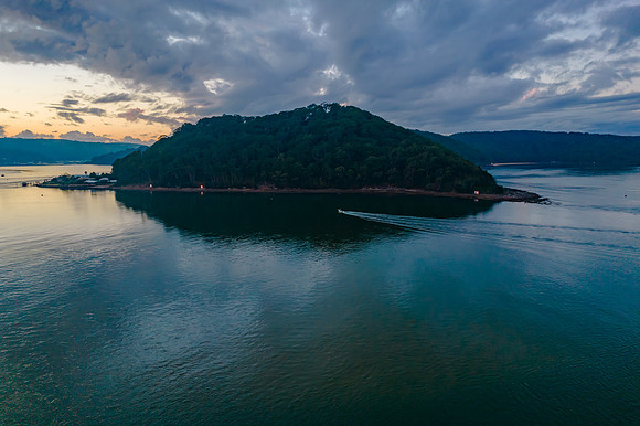 Aerial sunrise waterscape with boats and cloud cover
