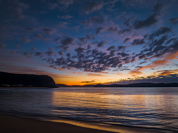 Aerial sunrise seascape with pretty cloud filled sky